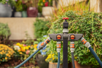 Gardena garden hose splitter with multiple connectors in a lush garden setting., miniatuur 3