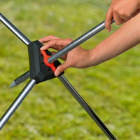 A person assembling a garden tool with metal rods and a central connector., miniatuur 4