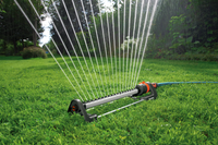 Oscillating sprinkler watering a lush green lawn in a garden setting., miniatuur 6