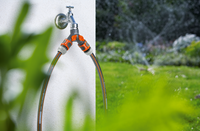 A dual garden hose connector attached to an outdoor faucet, with a garden in the background., miniatuur 5