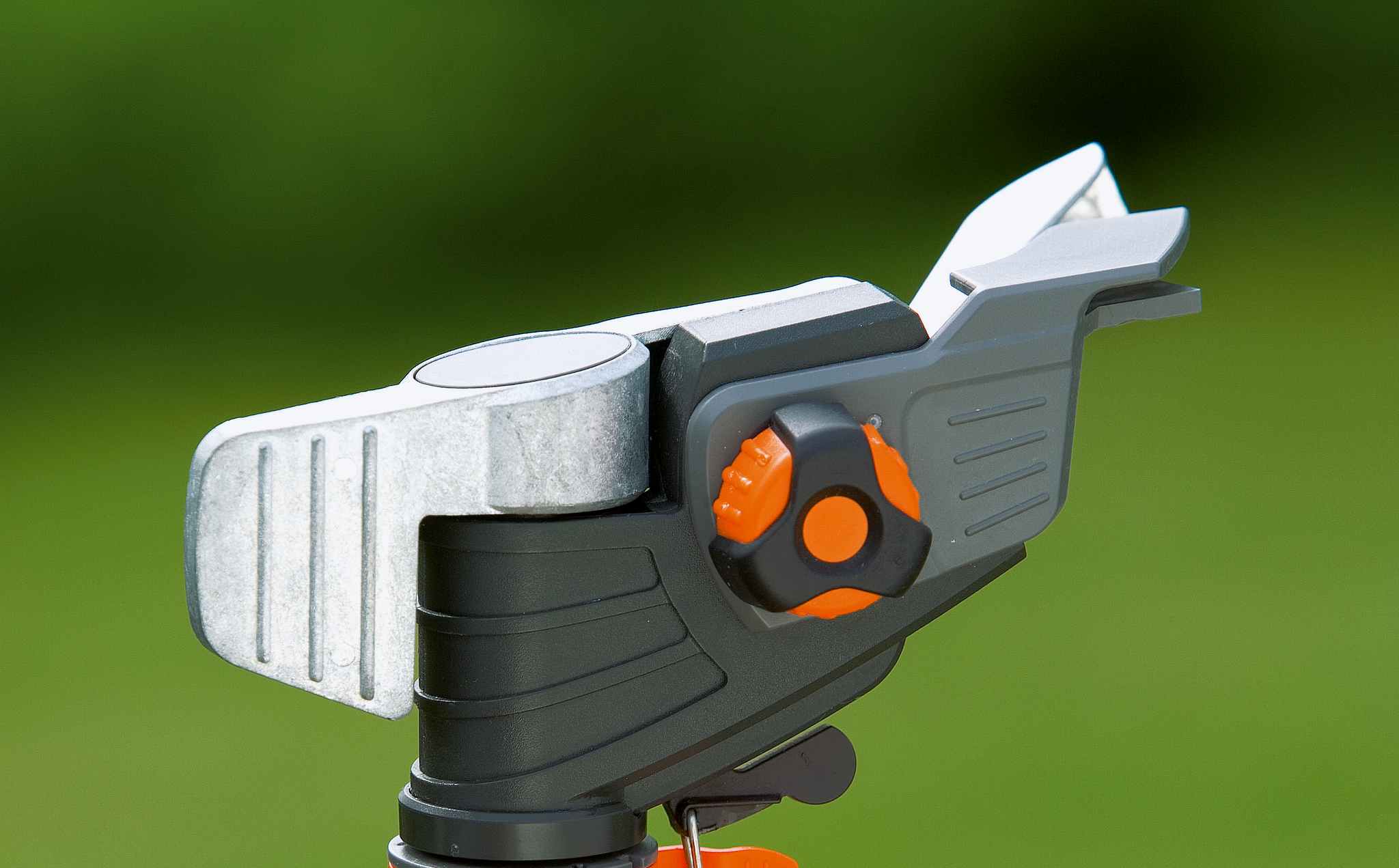 Close-up of a garden pruning tool with an adjustable cutting mechanism.