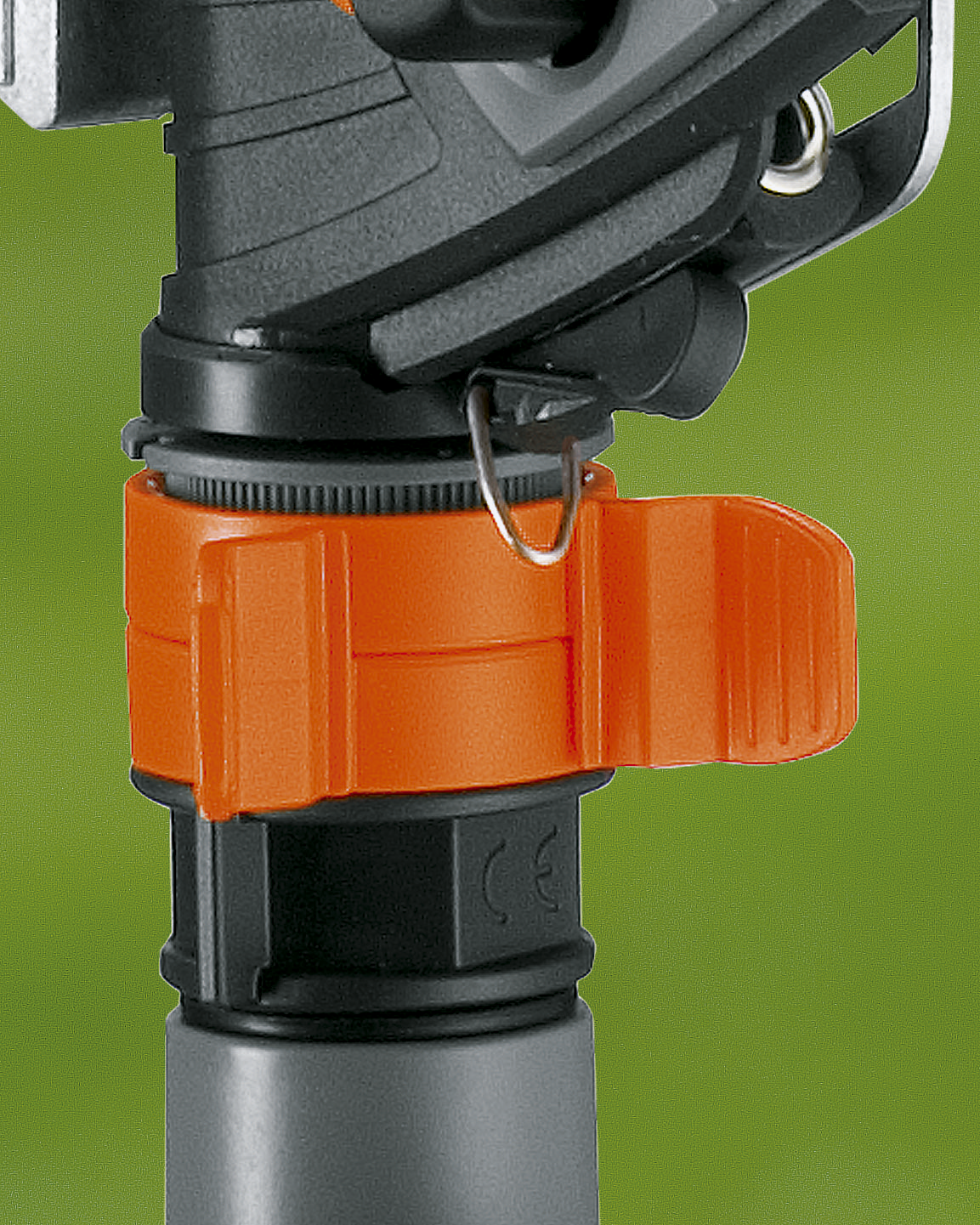 Close-up of a Gardena garden hose connector with an orange locking mechanism.