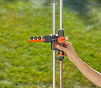 A person adjusting a Gardena water distribution system in a garden., miniatuur 4