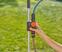 A person adjusting a Gardena water control valve in a garden setting., miniatuur 6