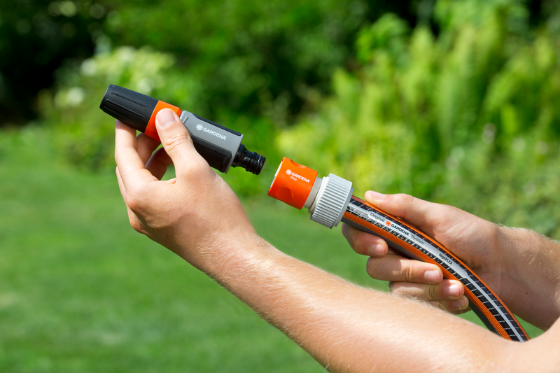 A person connecting a Gardena hose with a water stop connector in a garden., afbeelding 2 Slangkoppeling