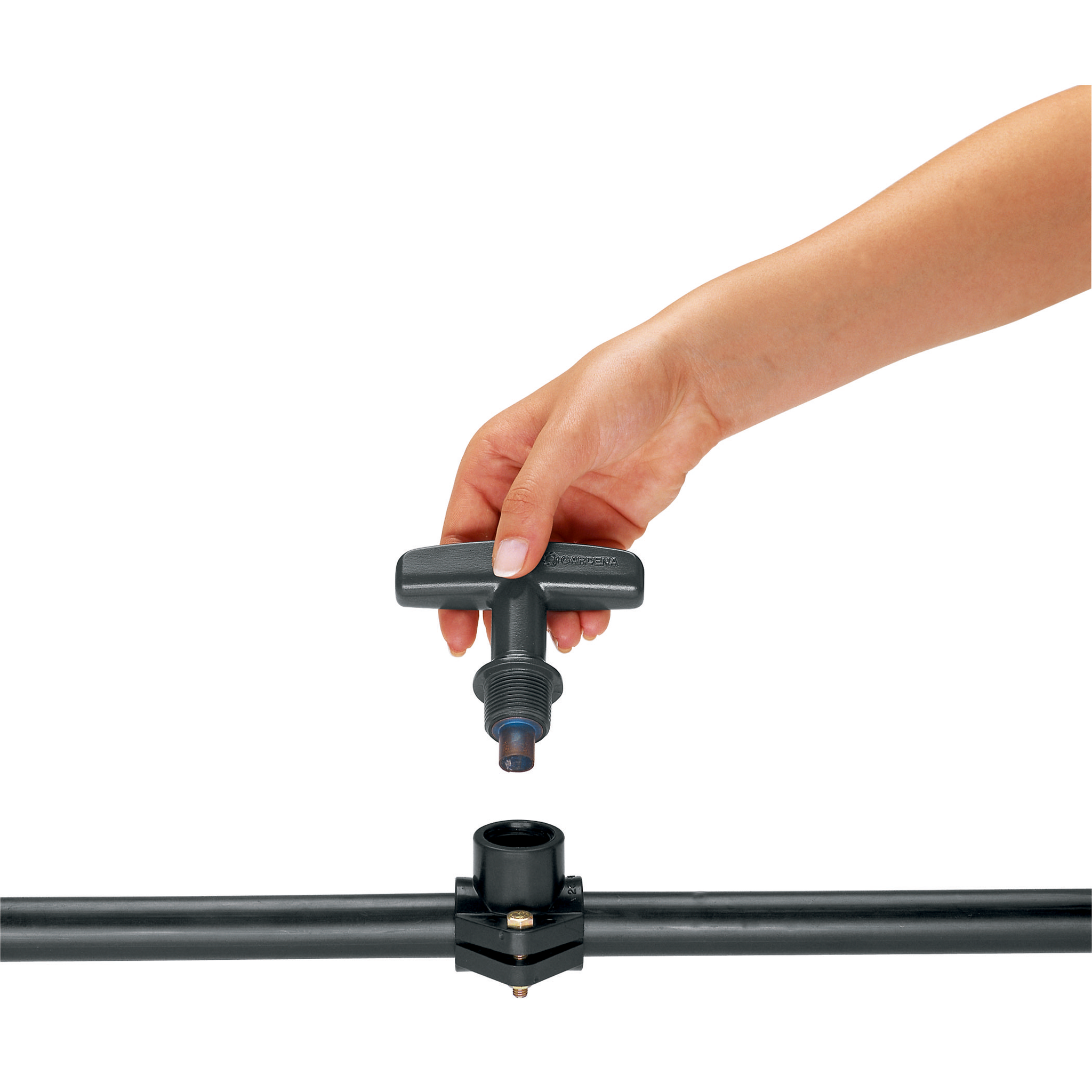 A hand installing a Gardena water valve onto a pipe.