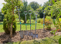 Four Gardena gardening tools, including shovels and a fork, standing upright in a garden., miniatuur 4
