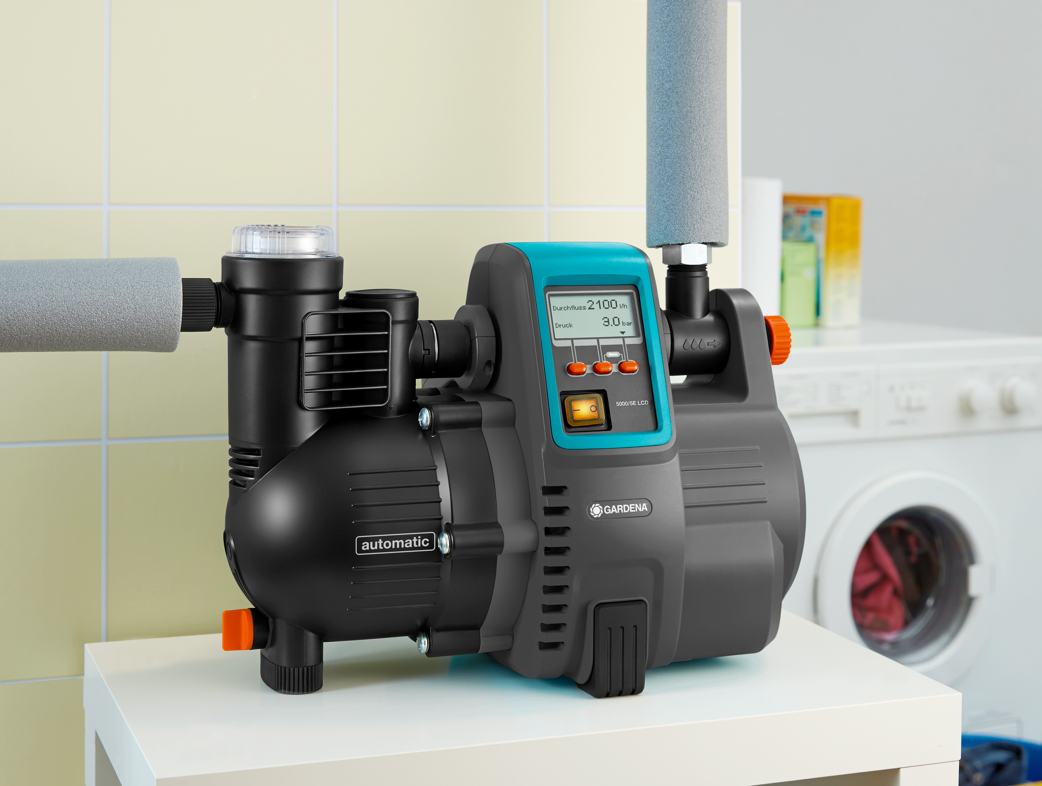 Gardena automatic water pump displayed indoors next to a washing machine.