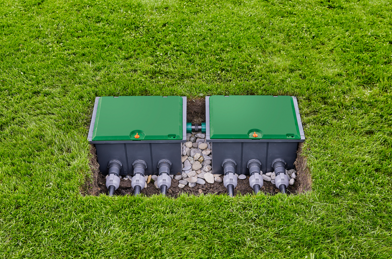Two irrigation control boxes installed in a grassy area, surrounded by small stones., afbeelding 3 Tuingereedschap