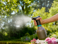 A person using a garden sprayer in a lush garden setting., miniatuur 4