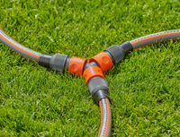 Three garden hoses connected with Gardena hose connectors on a grassy lawn., miniatuur 3