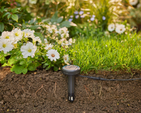 A soil moisture sensor placed in a garden bed, surrounded by blooming flowers and grass., miniatuur 4