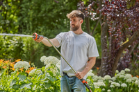 A person watering plants in a garden using a Gardena hose nozzle., miniatuur 5